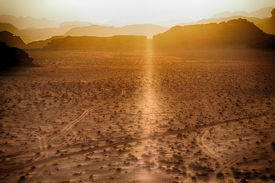 Scenic view of land against sky during sunset