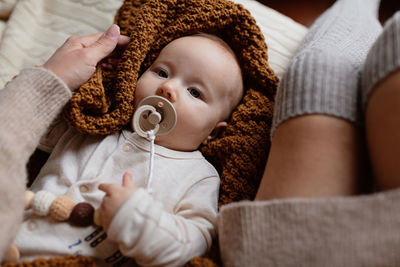 Portrait of cute baby girl lying on bed at home