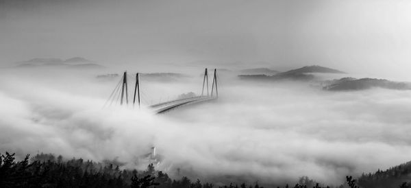 Panoramic view of bridge and mountains against sky