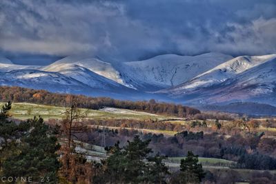 Scenic view of mountains against cloudy sky