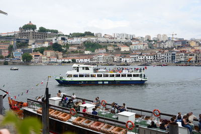 High angle view of boats in river against buildings