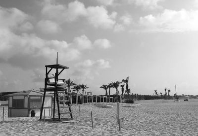 Lifeguard hut on beach against sky