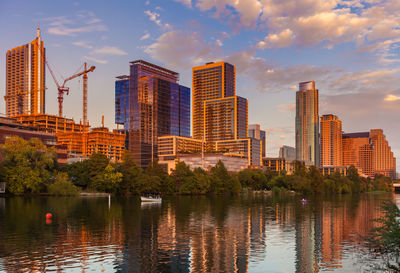 City by river against sky