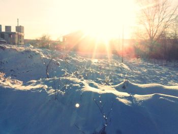 Scenic view of frozen lake against sky during sunset