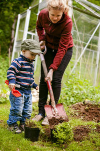 Mother with son gardening