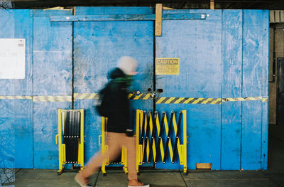 Full length of man standing against wall