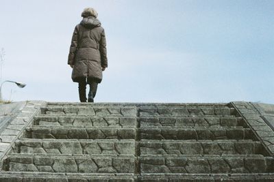 Low angle view of woman walking on staircase