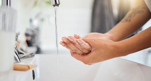 Midsection of woman washing hands