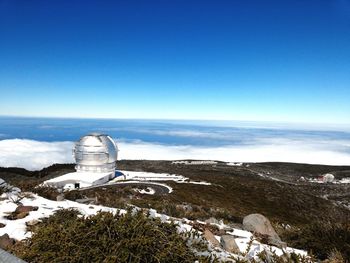 Scenic view of landscape against blue sky