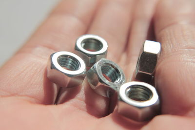 Close-up of hand holding bolts