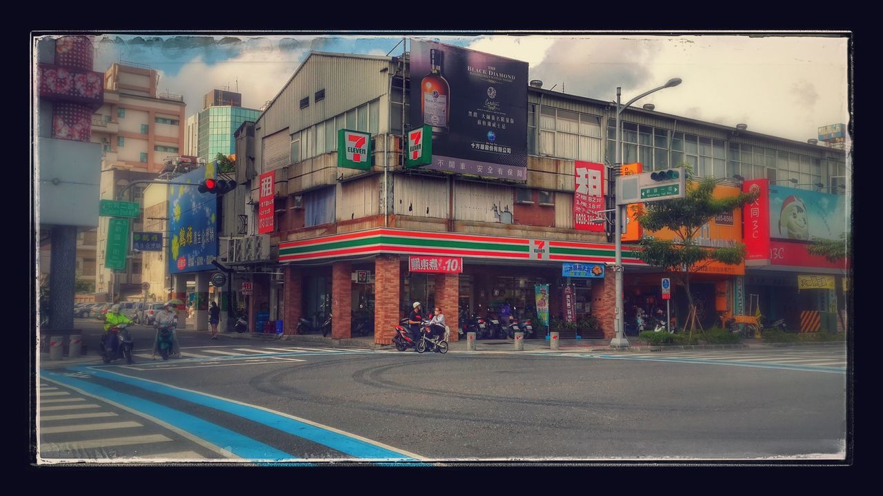 transfer print, auto post production filter, architecture, building exterior, built structure, street, city, road, transportation, sky, incidental people, graffiti, multi colored, city life, outdoors, road marking, building, sidewalk, day, car