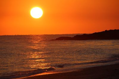 Scenic view of sea against romantic sky at sunset