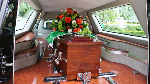 Closeup shot of a funeral casket in a hearse or chapel or burial at cemetery