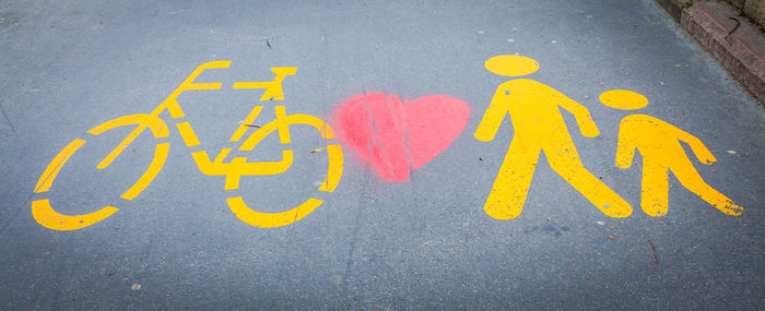 High angle view of bicycle lane with walk sign and heart shape