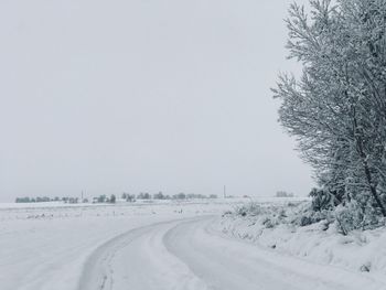 Snow covered field against sky