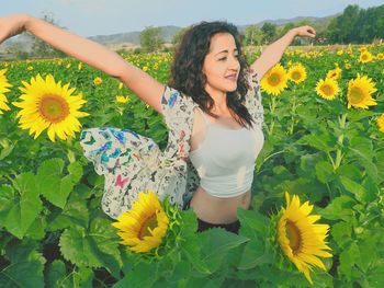 Woman with yellow flowers in field