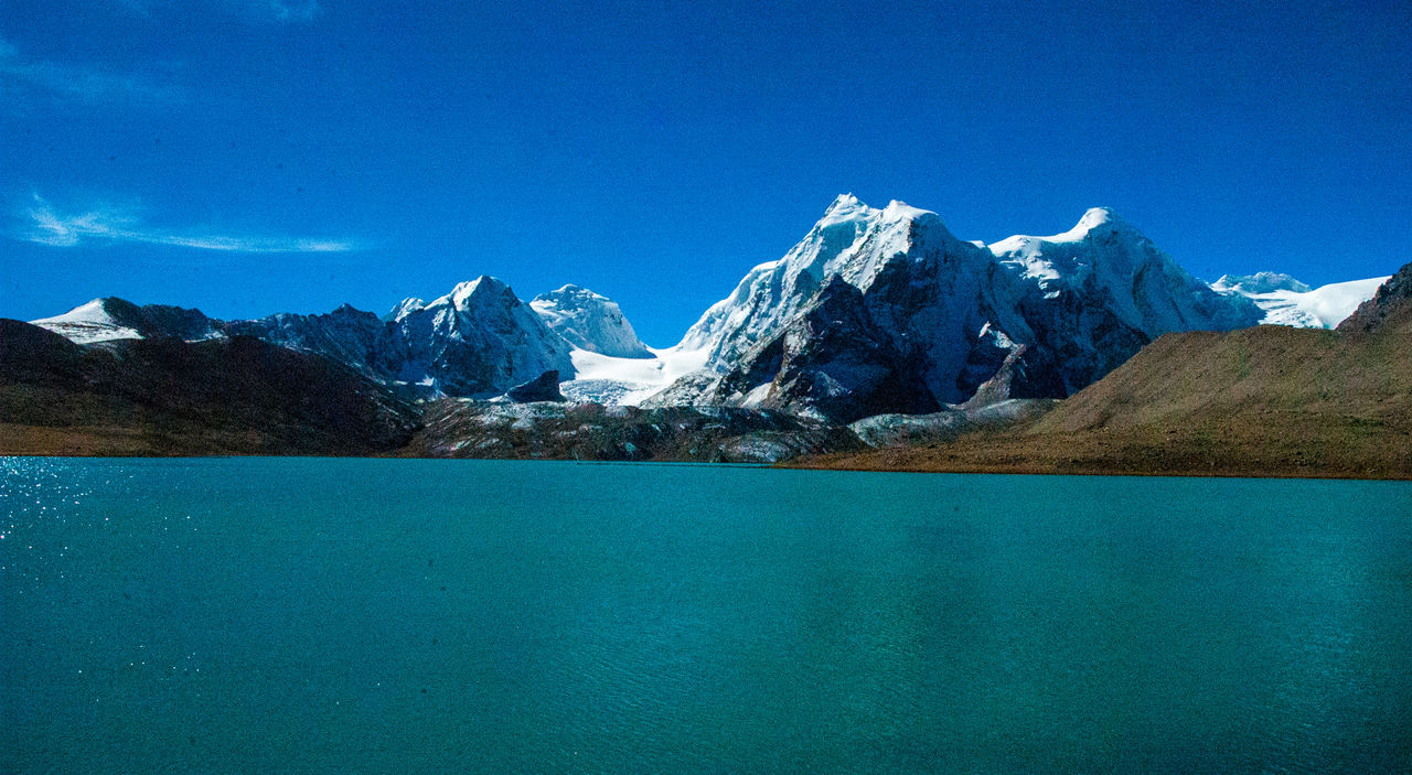 SNOWCAPPED MOUNTAINS AGAINST BLUE SKY