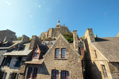 Low angle view of buildings against blue sky