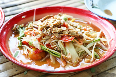 Thai spicy papaya salad on table