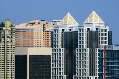 Low angle view of high rise buildings against sky in city