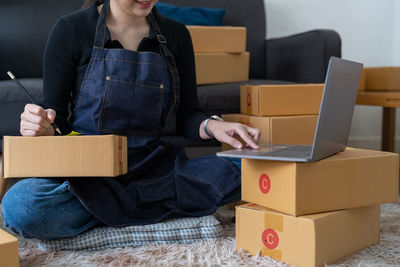 Midsection of woman using laptop