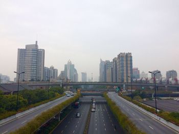 View of city street and buildings against sky