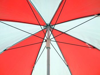 Low angle view of red umbrella against sky