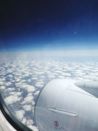 Aerial view of cloudscape over airplane wing