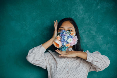 Portrait of a beautiful young woman covering face