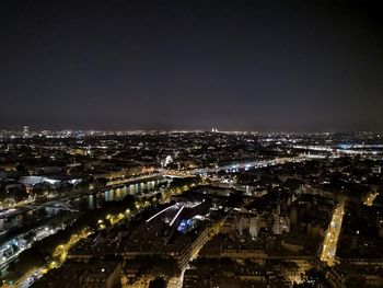 High angle view of illuminated city against sky at night