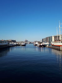 Boats moored at harbor