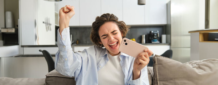 Young woman using digital tablet at home