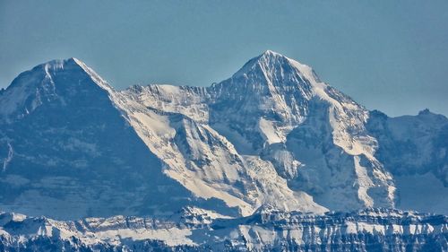 Aerial view of snowcapped mountains against sky