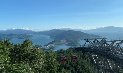 Panoramic view of bridge and mountains against sky