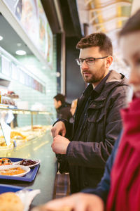 Young man having food in restaurant