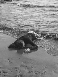 Man lying on shore