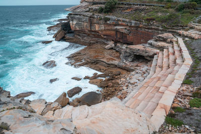 High angle view of rocks on beach against sky