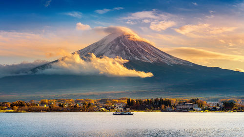 Scenic view of lake and mount fuji against sky during sunset