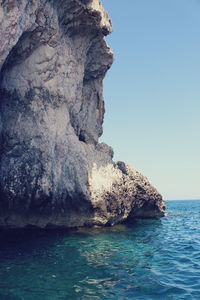 Scenic view of sea with rocks in background