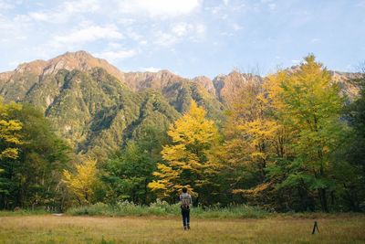 Man standing on grassy landscape