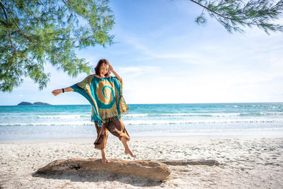 Full length of person on beach against sky
