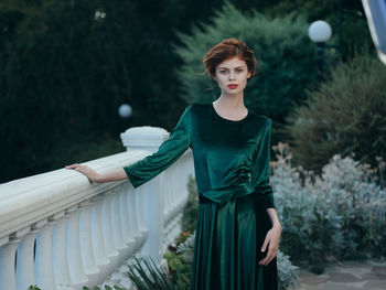 Portrait of young woman standing outdoors