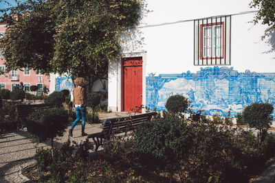 Full length of woman walking towards house