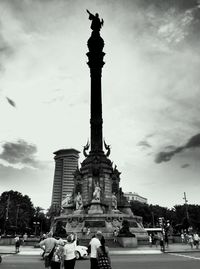 Low angle view of eiffel tower against cloudy sky