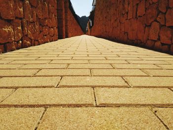 Shadow of woman walking on footpath