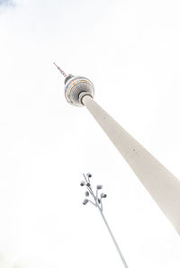 Low angle view of communications tower against sky