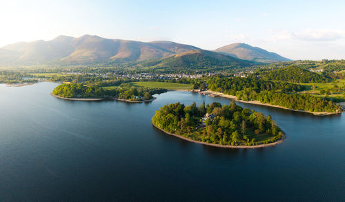 Scenic view of lake and mountains against sky