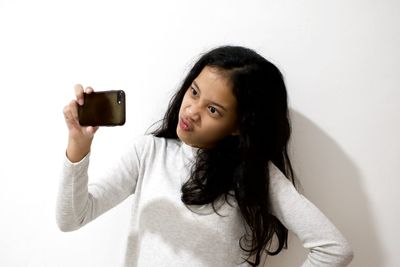 Portrait of young woman using mobile phone