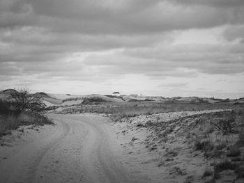 Scenic view of road against sky during winter