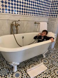 Portrait of woman in bathtub at home